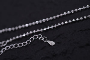 Elegant S925 silver beaded chain necklace on black background. Simple, delicate style.