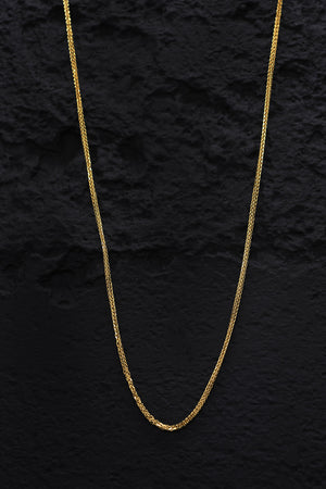 Gold plated minimalist curb chain necklace on black background. Delicate, textured design. Sterling silver.