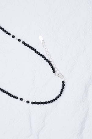 Elegant black beaded necklace with delicate silver accents on adjustable chain. Minimalist style. Tibetan dzi beads.