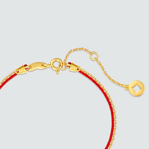 Elegant red string bracelet with gold diamond-shaped clasp and extender chain. Buddhist prayer beads for simple, mindful style.