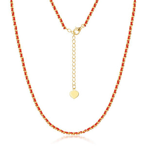 Gold-plated silver and red string necklace close-up on white. Elegant, minimalist design with heart charm. Ideal for daily wear.