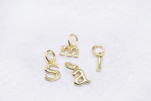 Gold letter charms spelling "Smai" on a white background. Personalize your jewelry with initial charms."