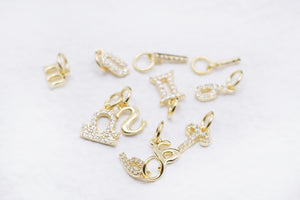 Gold zodiac charms with stones: Libra, Gemini, Scorpio, Pisces, Sagittarius & key charms.