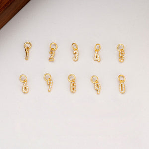 Gold number charms with gemstones. Image shows numbers 1-9 and 0. Perfect for DIY jewelry making and personalized accessories.