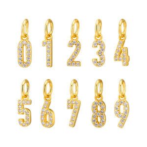 Gold number charms 0-9 encrusted with cubic zirconia. Sterling silver zodiac talisman necklace; lucky numbers for personalized jewelry design.