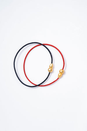 Red & black braided cord bracelets with gold charms. Tibetan prayer beads style for mindful meditation.