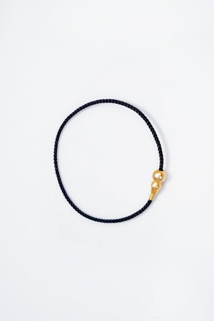 Elegant black braided cord bracelet with gold double-bead accent. Minimalist style, perfect for everyday wear. Buddhist prayer beads.