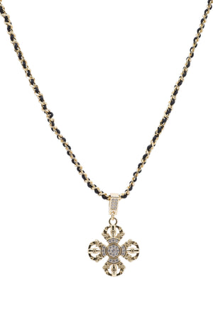 Gold Vajra pendant necklace on black cord. Tibetan Buddhist symbol of wisdom and protection, featuring clear stones.