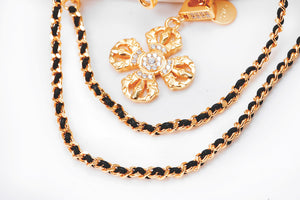 Gold & black chain necklace with four-lobed pendant and clear stones. Elegant, bohemian style. Tibetan dzi beads.