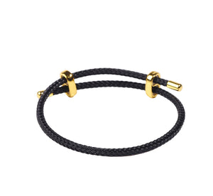Black and gold braided bracelet with adjustable band and gold accents. Simple, stylish everyday jewelry.