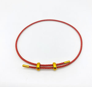 Red cord bracelet with gold beads. Delicate and stylish.