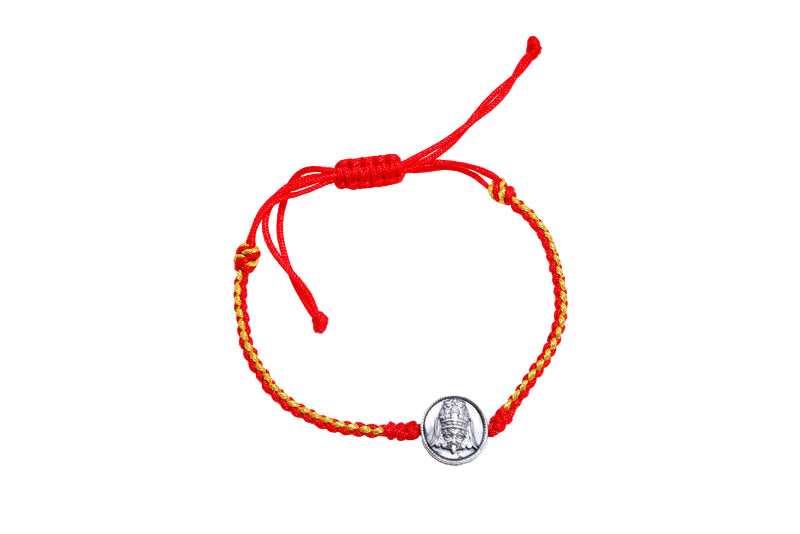 Red & gold braided Tibetan bracelet with silver Pope John Paul II medallion. Adjustable for comfortable wear. Offers luck & protection.