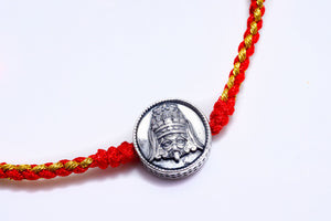 Red and gold braided bracelet with silver emperor charm. Tibetan dzi beads style, perfect for spiritual jewelry.