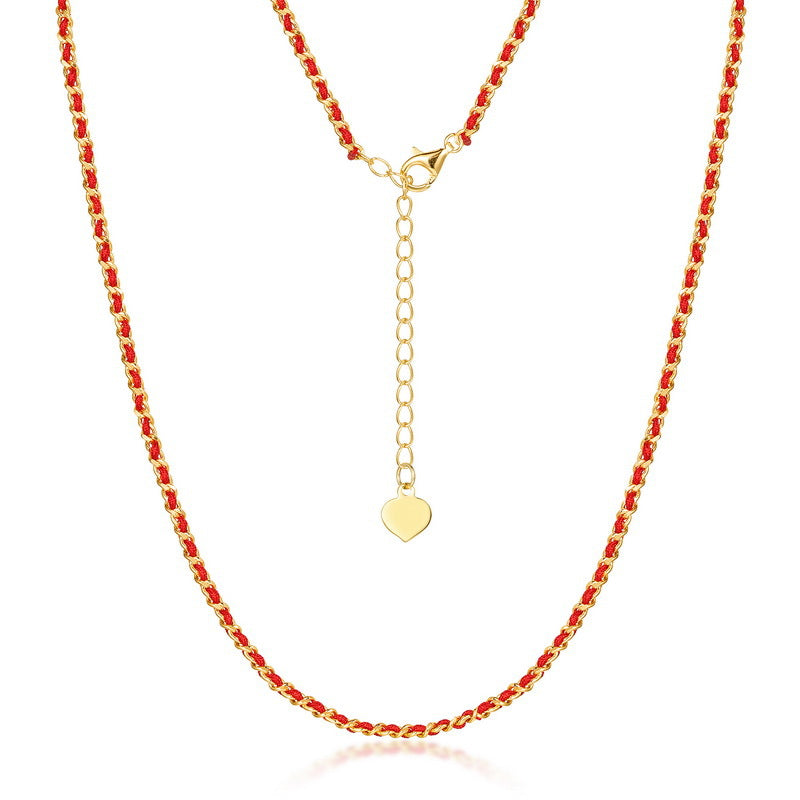 Gold-plated silver and red string necklace close-up on white. Elegant, minimalist design with heart charm. Ideal for daily wear.