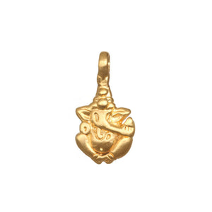 Golden Ganesha pendant charm, a symbol of success and remover of obstacles. Detailed Hindu deity jewelry on a red string bracelet.
