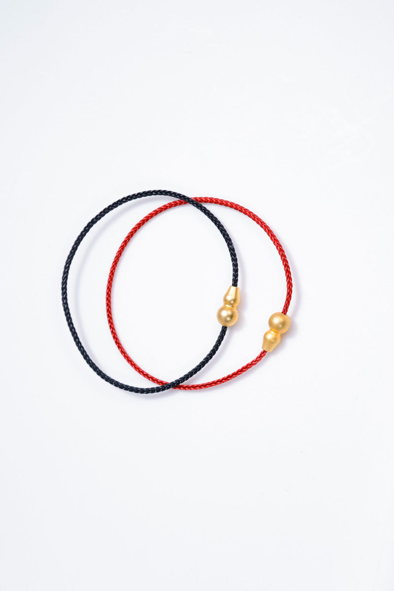 Red & black braided cord bracelets with gold charms. Tibetan prayer beads style for mindful meditation.