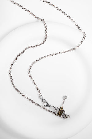 Elegant silver necklace with two-tone prayer wheel pendant. Tibetan dzi beads inspire this minimalist, spiritual jewelry piece.
