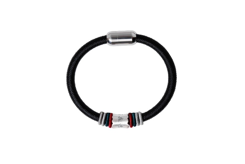 Black braided Tibetan bracelet with silver Om Mani Padme Hum mantra bead and colorful accents on white background.