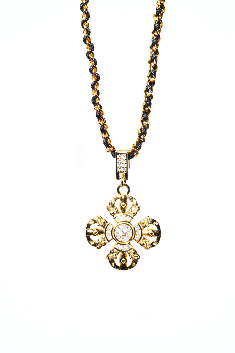 Elegant gold jeweled cross pendant on a black and gold chain. Tibetan dzi beads inspire this unique, spiritual necklace.